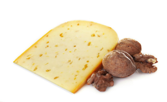 Cheese with walnuts and wine on light background