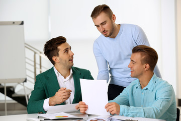Young business men at the meeting in a conference room