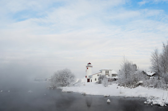 Lighthouse on the shore in the mist
