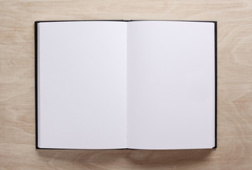 Open blank textbook on wooden background