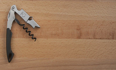 Wine opener on a wooden background