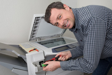 Closeup shot of technician fixing photocopier machine