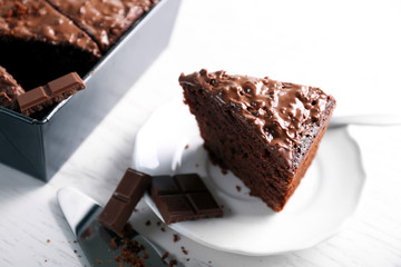 Delicious chocolate cake with nut cream on white table, close up