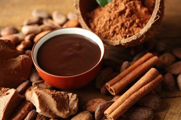 Aromatic cocoa harvest with tasty chocolate on wooden background, close up