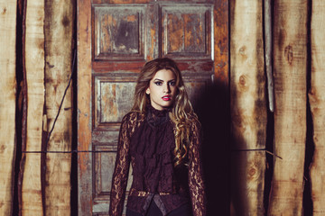 Girl with long blond curly hair on rustic door