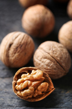 Walnuts on grey wooden table, close-up