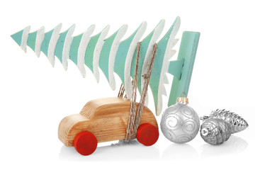 Wooden toy car with Christmas tree and toys, isolated on white