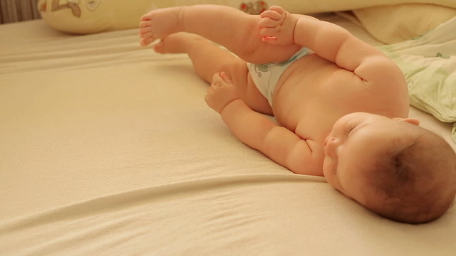 Baby Lying On His Side And Learns To Turn Over On A Stomach