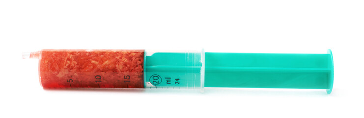 Medical syringe filled with red liquid