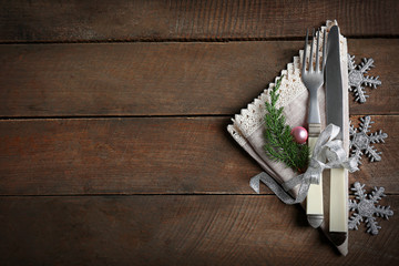 Christmas serving cutlery with napkin on a wooden background