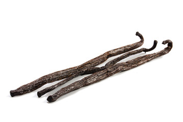 Three vanilla pods isolated with shadows on a white background