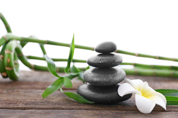 Spa stones with bamboo and tropical flower on white  background