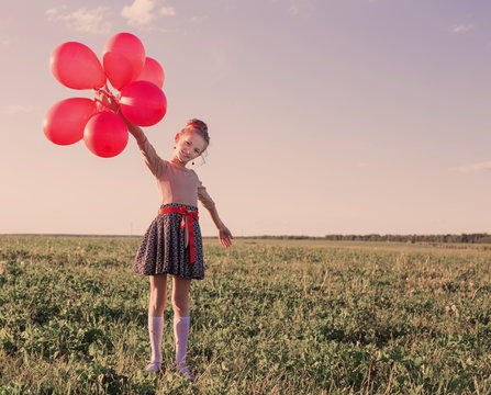 Happy Girl With Red Balloons Outdoor