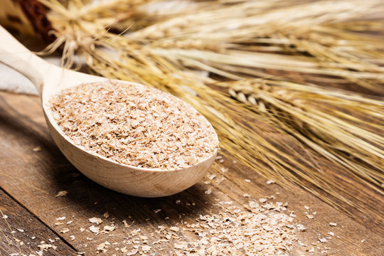 Closeup Of Wooden Spoon Filled With Wheat Bran