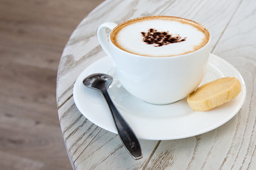  cappuccino coffee cup on wood table at coffee shop
