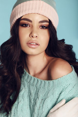 beautiful young girl with dark hair wears cozy warm knitted clothes