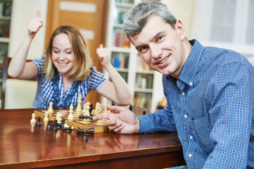 boy playing chess at home