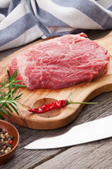 Raw beef steak with spices and herbs