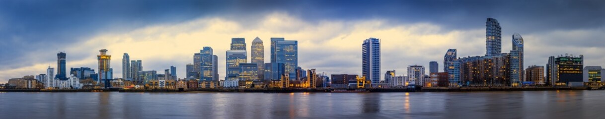 Fototapeta na wymiar Wide panoramic skyline of Canary Wharf, the worlds leading financial district at blue hour - London, UK 