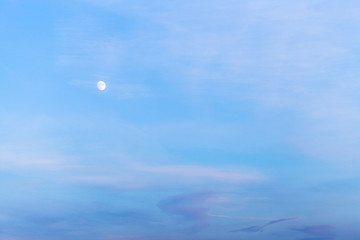 white moon in blue evening sky