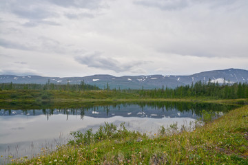 Fototapeta na wymiar Mountains on the shores of lake.