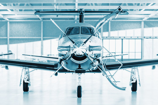 Single turboprop aircraft in hangar. 
