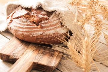 bread and wheat on the wooden background