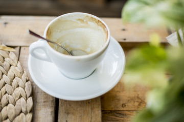 A cup of hot cappuccino in wood table