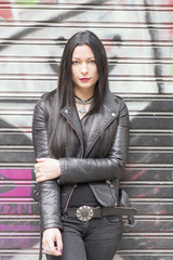 Fototapeta premium Urban portrait of beautiful woman heavy metal style.