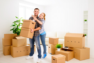 moving to a new apartment. Happy family couple and cardboard box