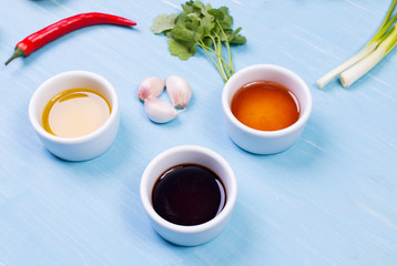 Food ingredients and kitchen utensils for cooking on wooden background