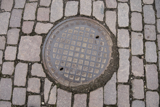 Manhole in paving stones