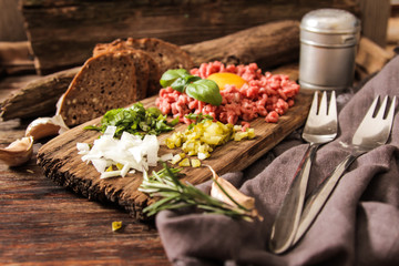 beer snack Beef tartare with pickled cucumber and fresh onion