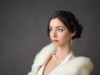 Bride in a white fur coat. Beautiful woman
