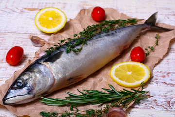 ingredients for baking scomber fillets, include raw mackerel, lemon, garlic, rosemary