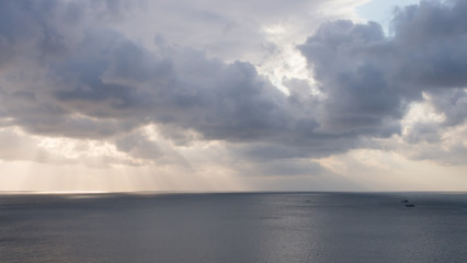Fototapeta na wymiar Beautiful seascape with sunbeams shine through cloudy sky