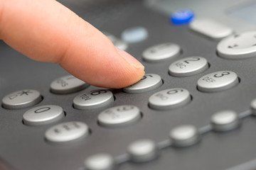 Fototapeta na wymiar closeup of businessman Dialing Number On Telephone Keypad