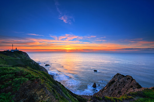 Sunset on the rocky coast in Cabo da Roca, Portugal.