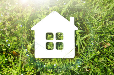 Toy house on grass background