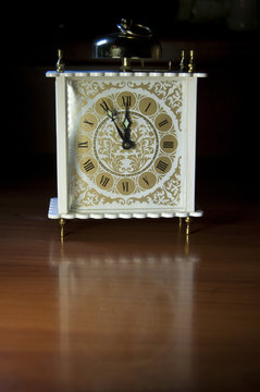 old vintage clock on wooden background