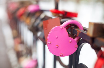Vintage closed pink padlock in heart shape Close Up on a blurred