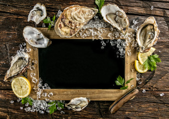 Oysters served on wood with blackboard