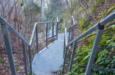 Fototapeta na wymiar Iron staircase in a wooded part of the mountain.