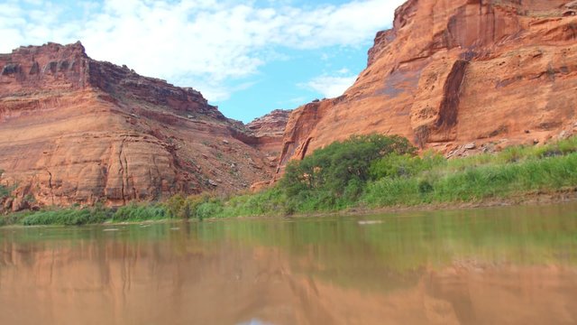 Water ripples in front of the red rocks of the Green River in Southeastern Utah.