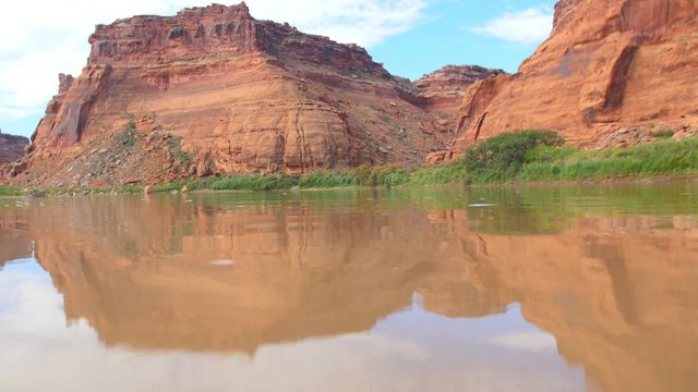 Water ripples in front of the red rocks of the Green River in Southeastern Utah.