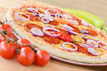 Pizza with pepperoni, onion and salami