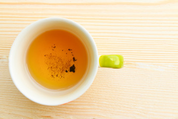 Cup of tea on bright wooden background