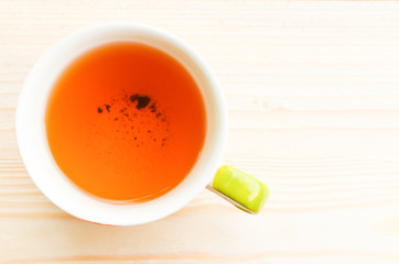 Cup of tea on bright wooden background