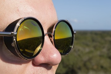 Man in round green dark sunglasses - goggles