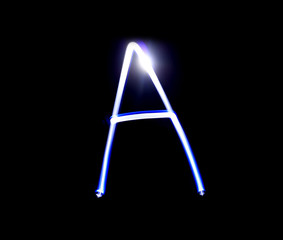 A Able alphabet hand writing blue light  over black background.